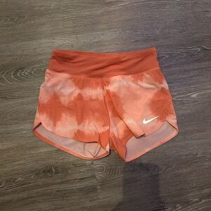 Nike Orange Athletic Shorts with Lightweight Fabric and Curved Hem
